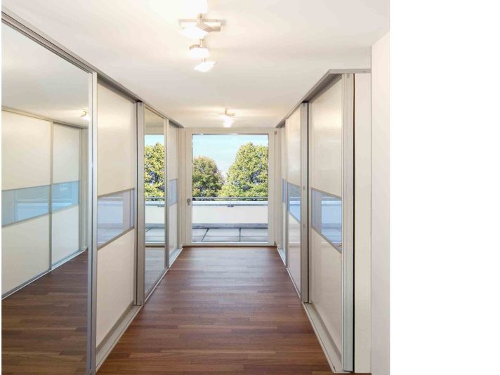 Ankleideraum mit Schiebetürschränken auf beiden Seiten